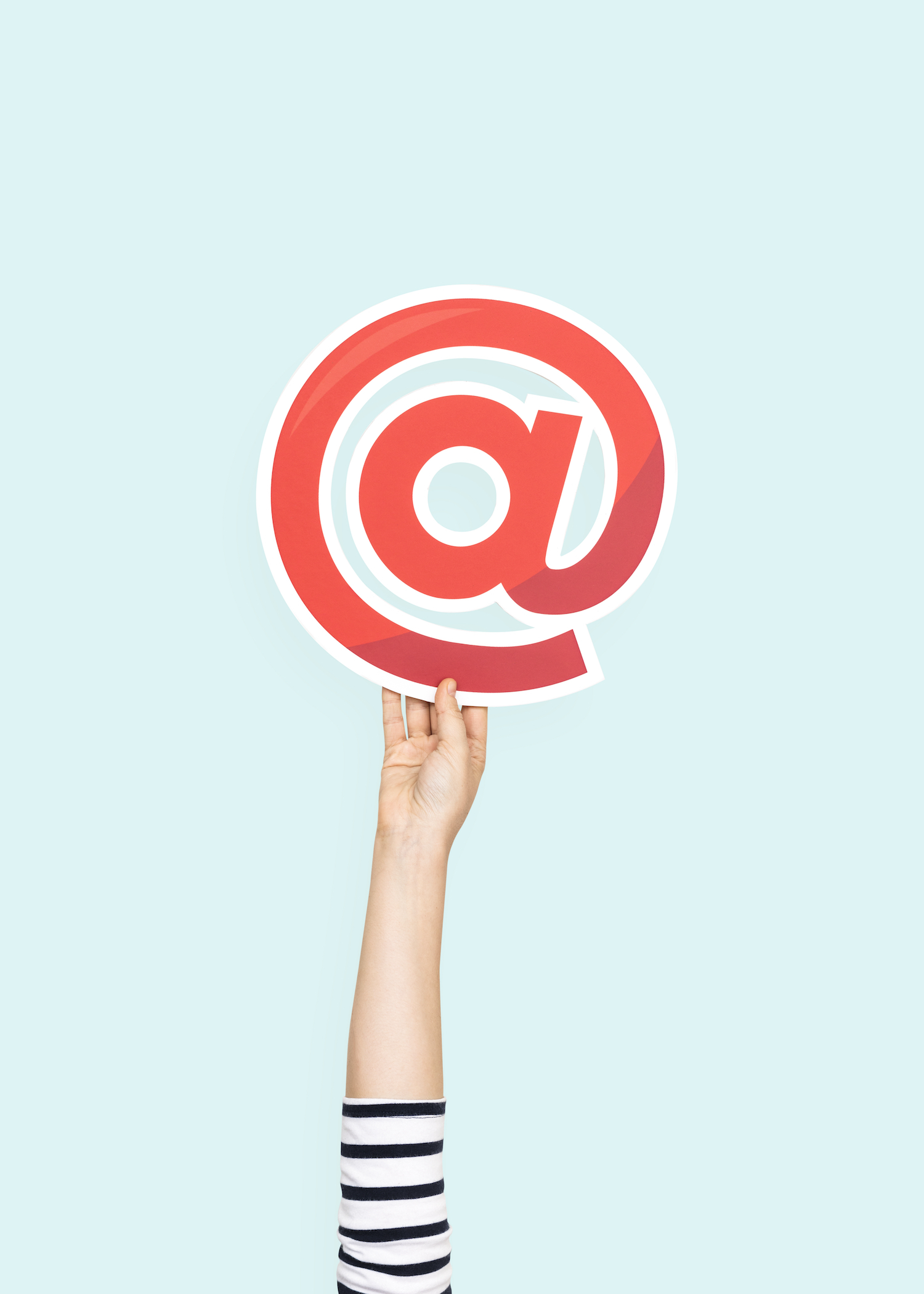 Hand holding @ symbol Last-Minute Holiday Marketing Ideas That Will Save Your Season